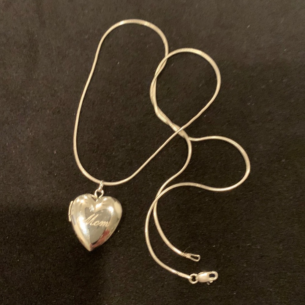 Silver heart locket with 16” chain.